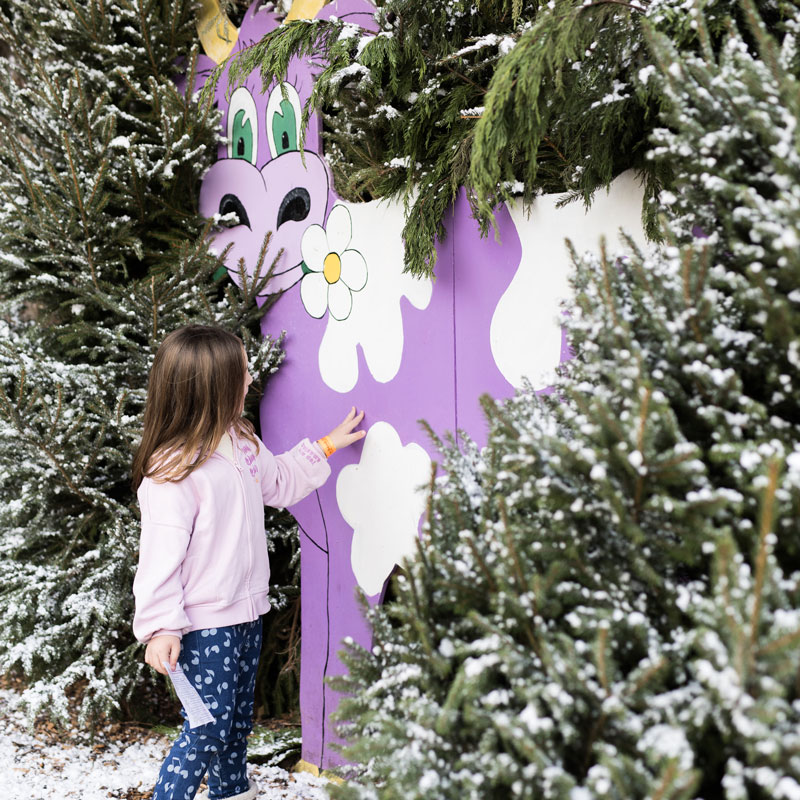 Girl with a purple cow in snowy field