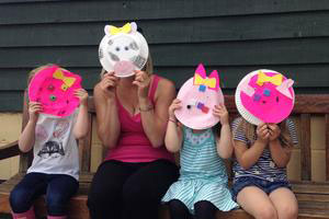 School group showing their pig crafts