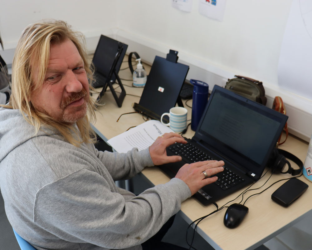 Academy: Supported person working a computer