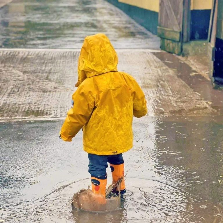 child on the farm in rainy weather