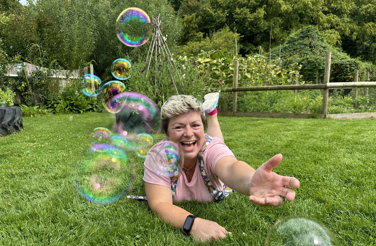 Siana in the grass with bubbles