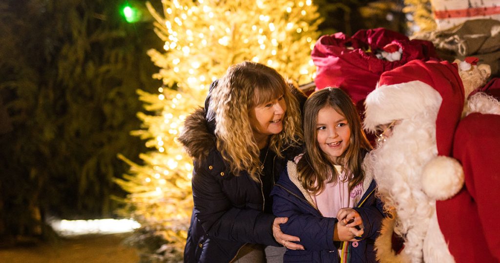 A picture of a girl and her nan with Santa