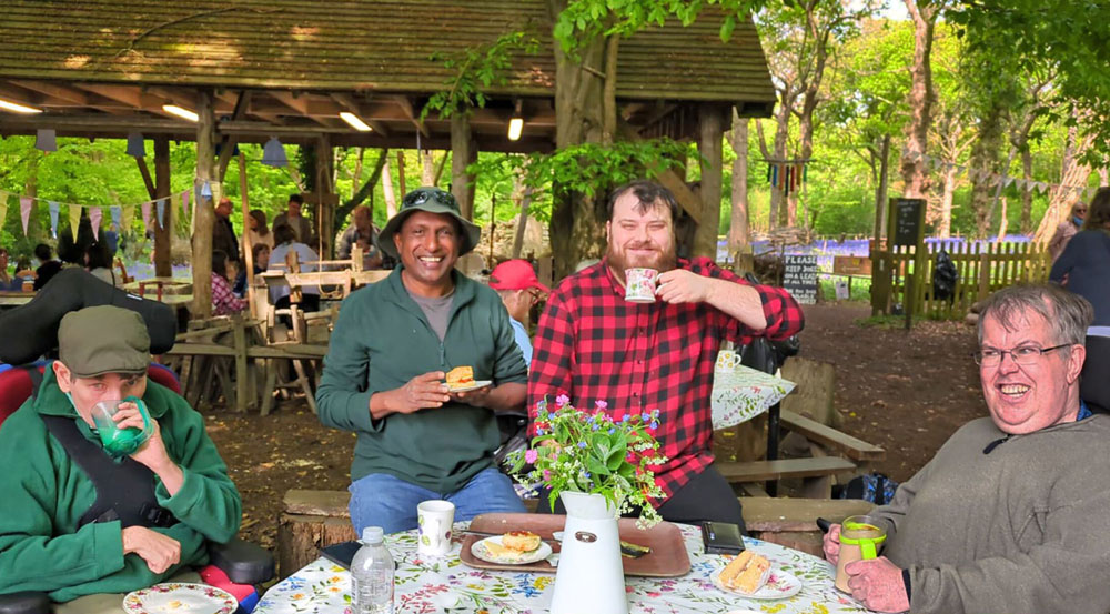 Picture of people enjoying a cream tea at Poulton Wood