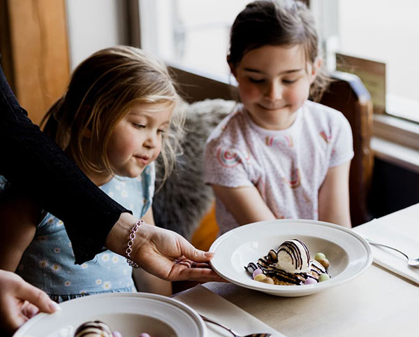 picture of girls receiving their dessert in restaurant