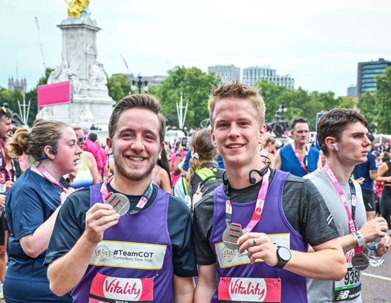 Picture of two young men with their medals after running a marathon