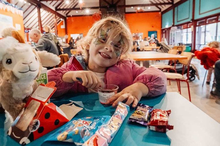 A girl eating in the Granary Restaurant at the Rare Breeds Centre