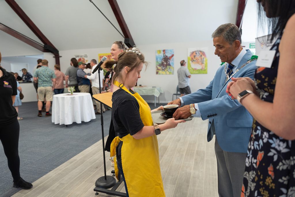 Rachel serving the mayor a coffee