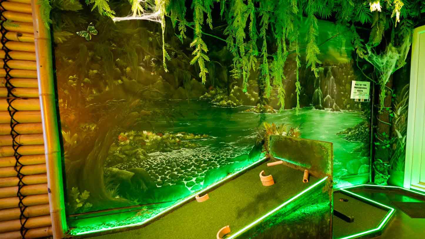 An image of an indoor tropical mini golf layout