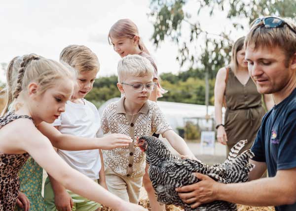 School group learning about chickens